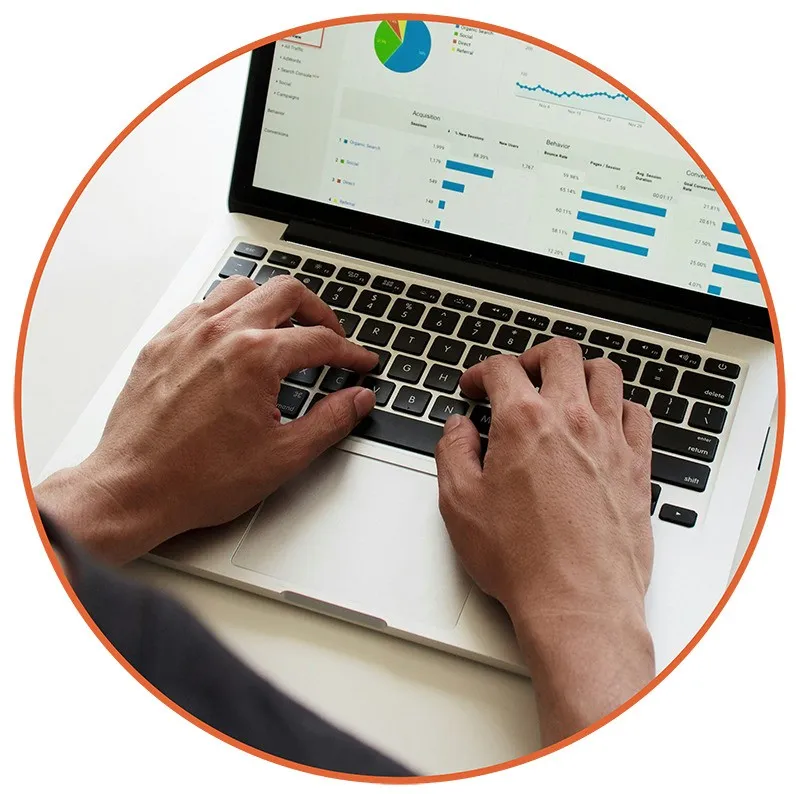 641 Hands typing on a silver laptop displaying colorful graphs and charts, suggesting data analysis or business work. The mood is focused and professional.