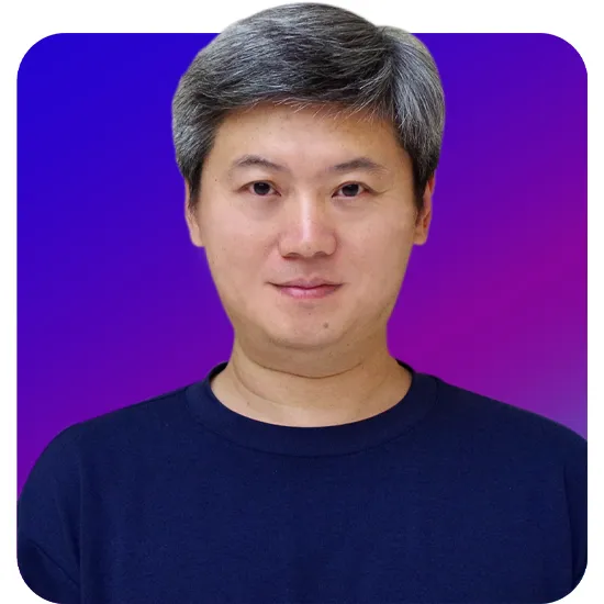 Portrait of a person with short gray hair and a subtle smile, wearing a dark blue shirt against a purple-blue gradient background. The tone is calm and professional.